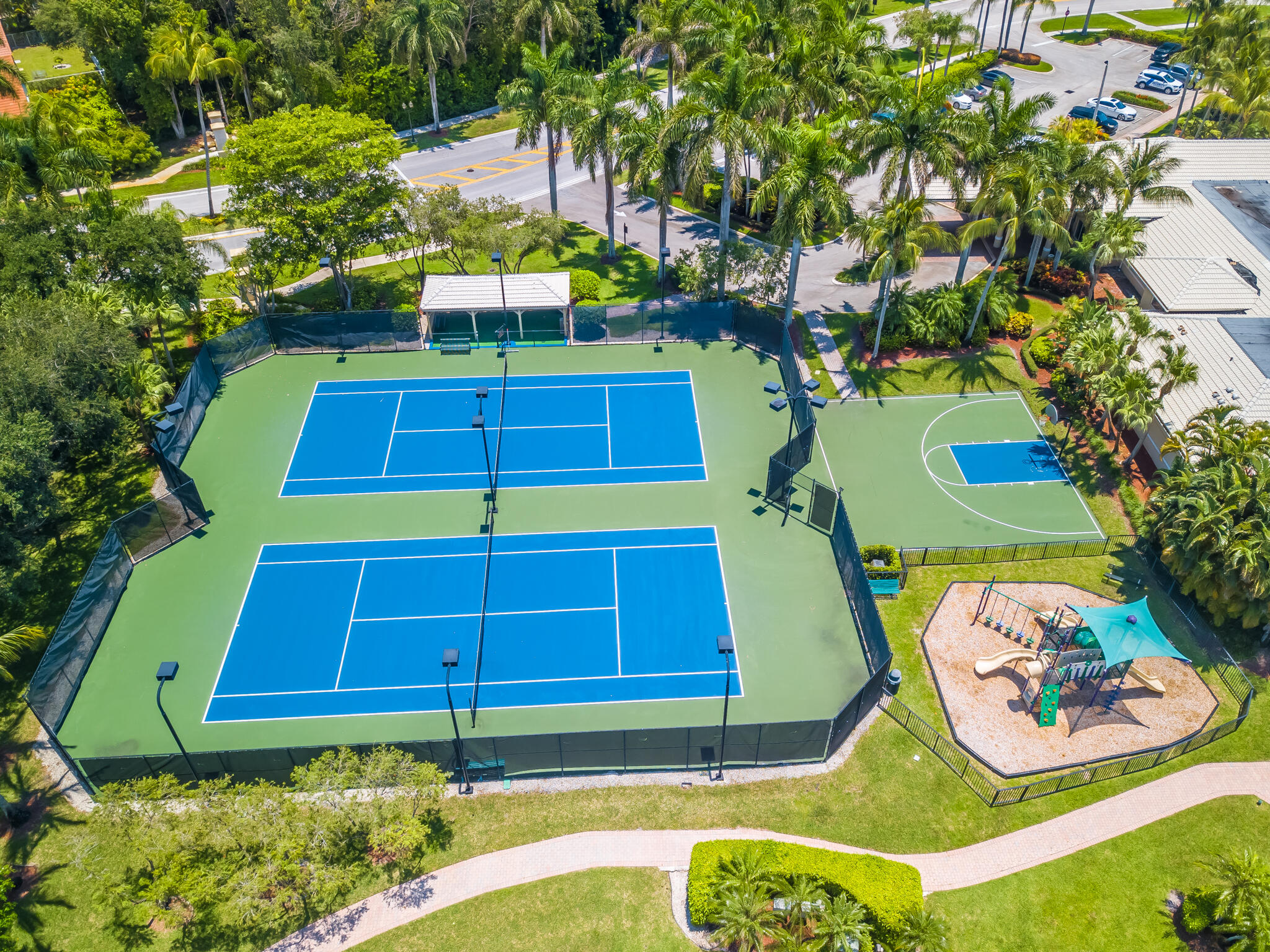 19916 Dinner Key Drive Boca Raton, FL 33498 - Photo 58 of 73 a view of a tennis ground with large trees