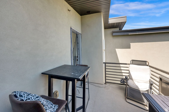 7713 Navarro View Court Midvale, UT 84047 - Photo 23 of 41 Private outdoor patio featuring a textured stucco exterior, a sliding glass door, and metal horizontal railings