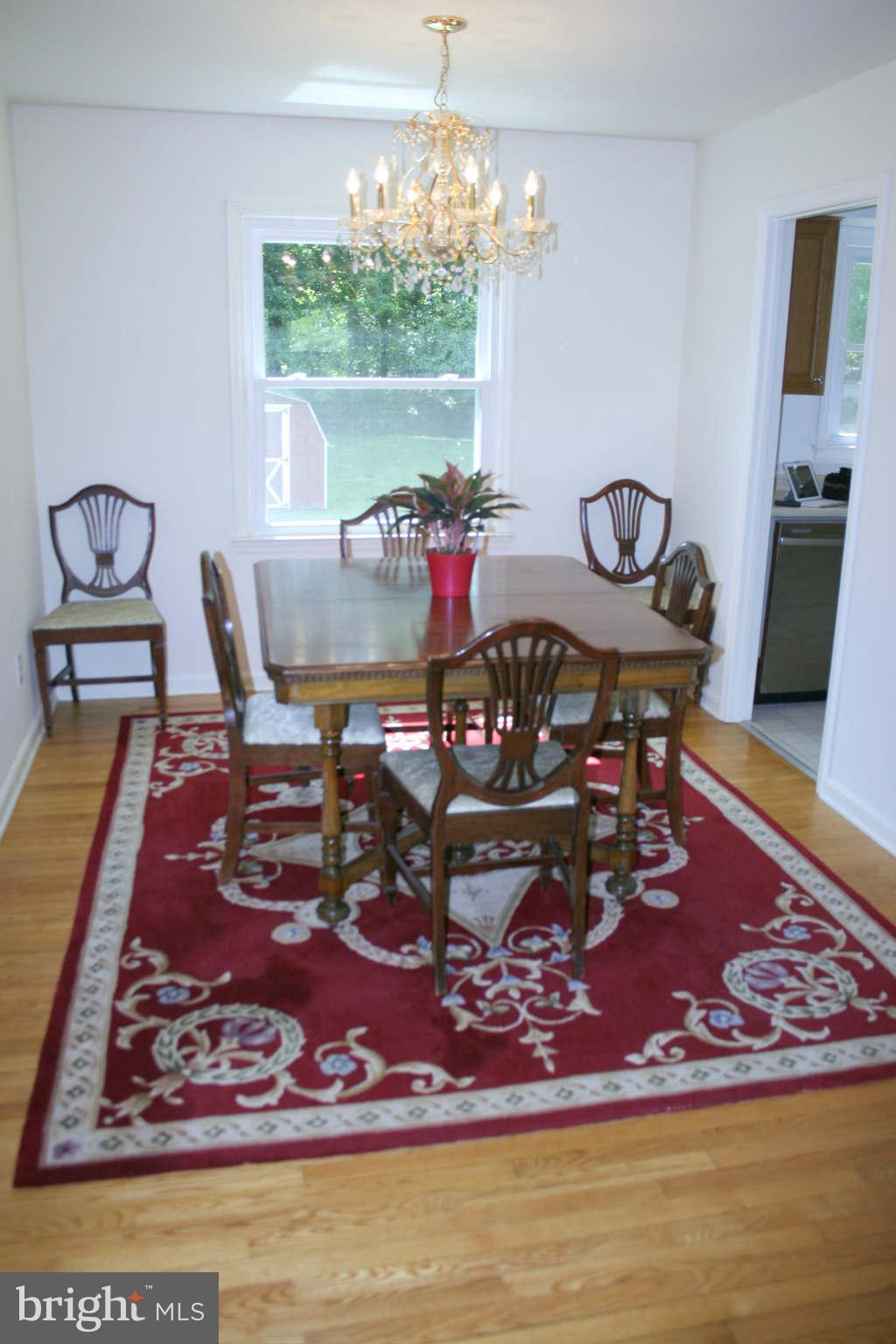 Dining Room w/Hardwood Flrs and Hanging Chandelier