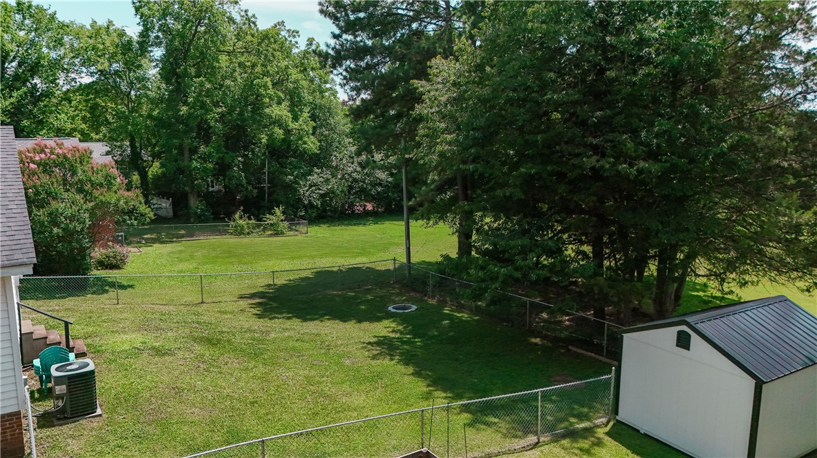 310 North Chestnut Street Seneca, SC 29678 - Photo 12 of 30 A generously sized yard, securely fenced, features mature trees and a practical storage shed.