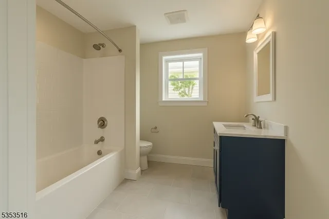 a bathroom with a bathtub sink vanity and toilet
