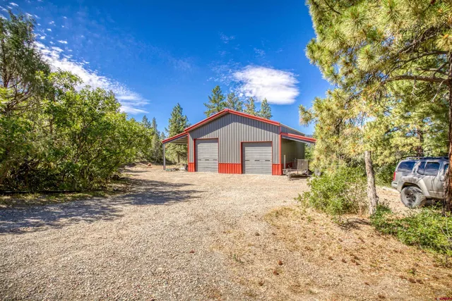 a view of house with backyard and trees