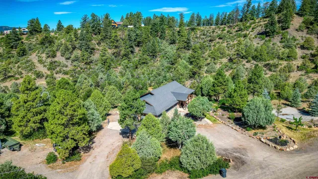 an aerial view of a house with a yard
