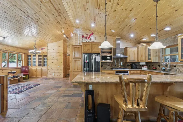 a large kitchen with a table and chairs