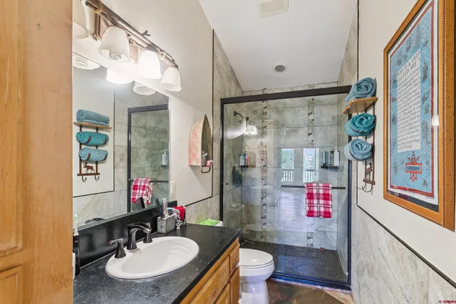 a bathroom with a sink toilet and shower