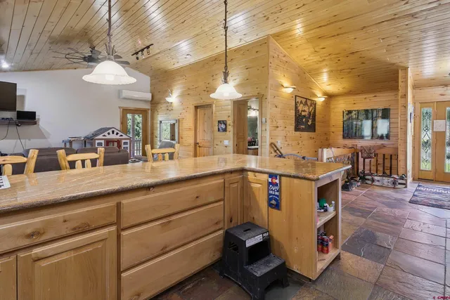 a kitchen with sink and chairs