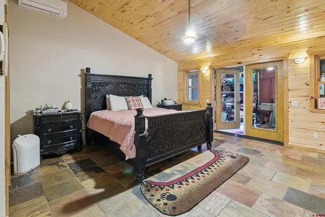 a bedroom with a bed and a mirror