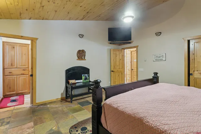 a bedroom with a bed and a chair