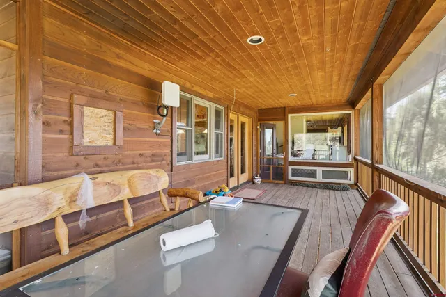 a view of a living room and kitchen with furniture wooden floor and windows