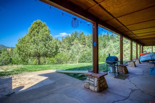 a swimming pool with outdoor seating and yard
