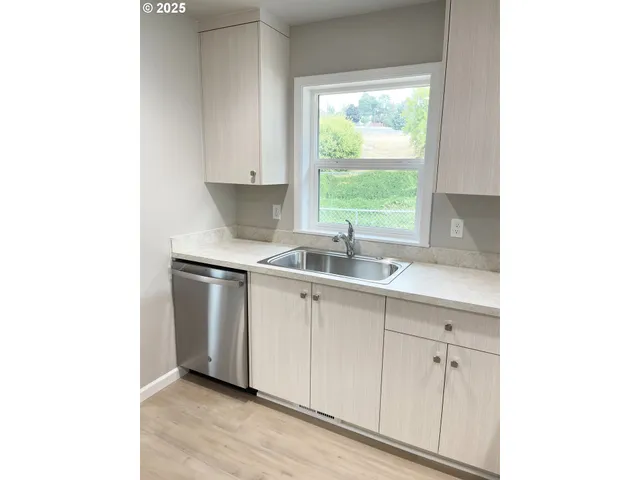 a kitchen with a sink and cabinets