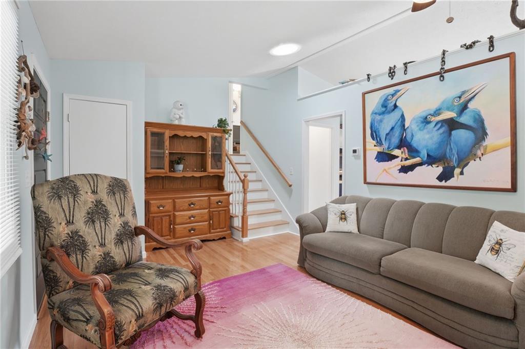 338 Arbour Way Suwanee, GA 30024 - Photo 4 of 32 a living room with furniture and a painting