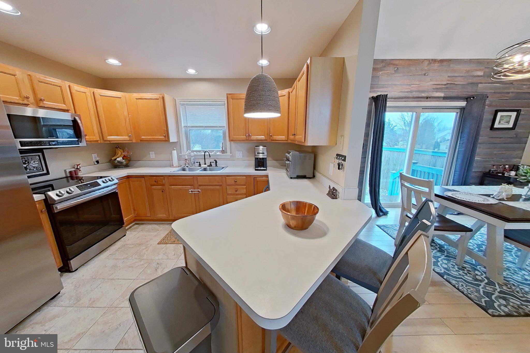 44 Duffield Drive Lititz, PA 17543 - Photo 5 of 10 a kitchen with a sink a stove and chairs