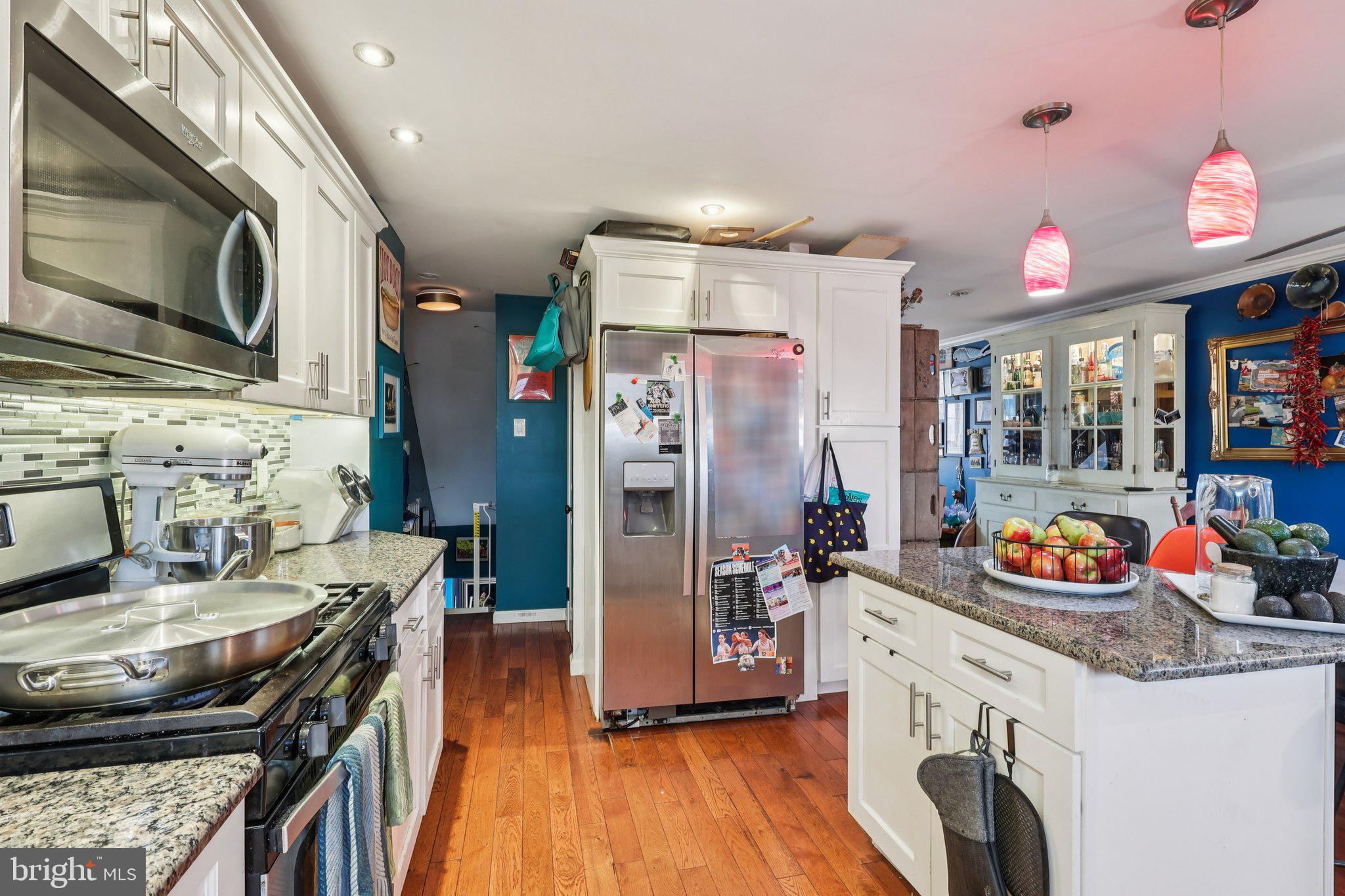 3442 Holyoke Road Philadelphia, PA 19114 - Photo 17 of 35 a kitchen with stainless steel appliances granite countertop a stove refrigerator and a microwave