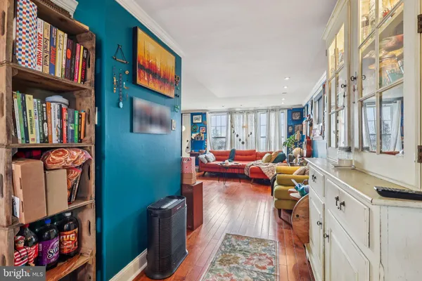 a living room with furniture and a book shelf