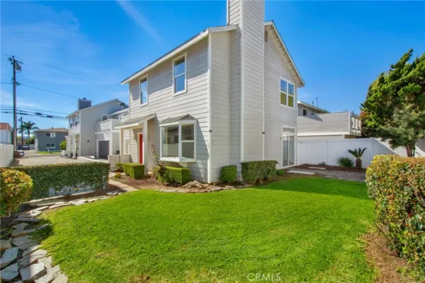 a front view of a house with a yard and outdoor seating