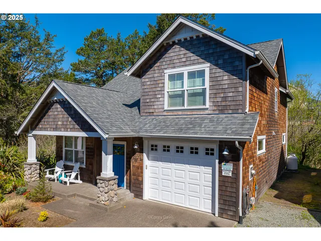 a front view of a house with a yard outdoor seating and mountain view