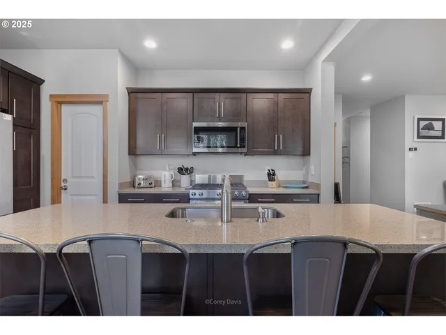 a kitchen with stainless steel appliances a sink stove and refrigerator