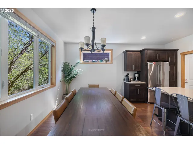 a kitchen with stainless steel appliances granite countertop a refrigerator a stove and a wooden floors