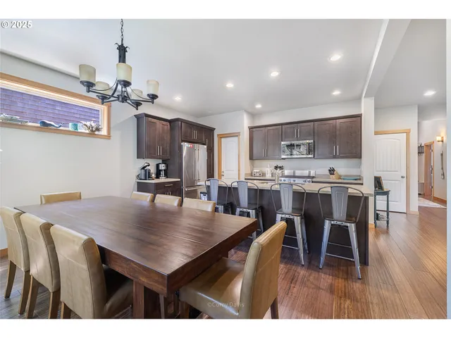 a open kitchen with kitchen island a dining table and chairs