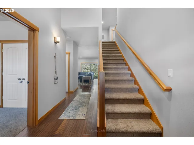 a view of entryway and hall with wooden floor