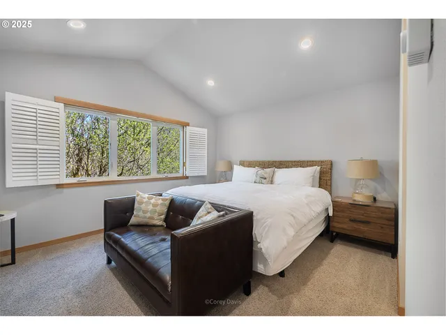 a bedroom with a bed and a couch with window