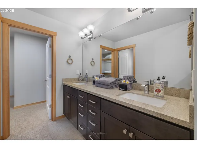 a bathroom with a sink double vanity granite and a mirror