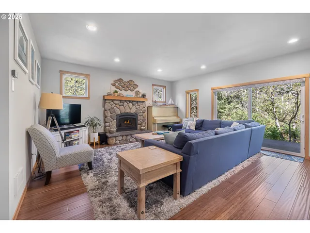 a living room with furniture a large window and a fireplace