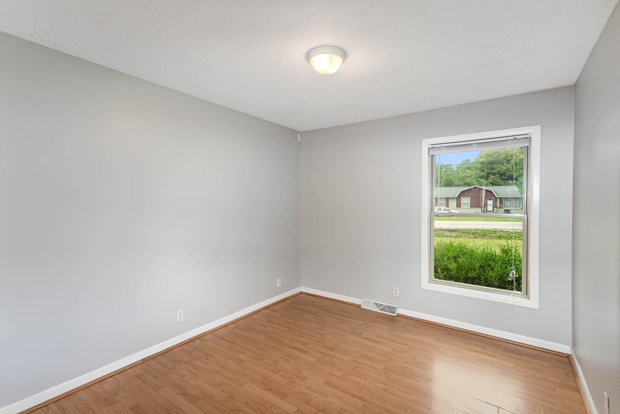 340 Dean Road Clarksville, TN 37040 - Photo 14 of 30 wooden floor in an empty room with a window