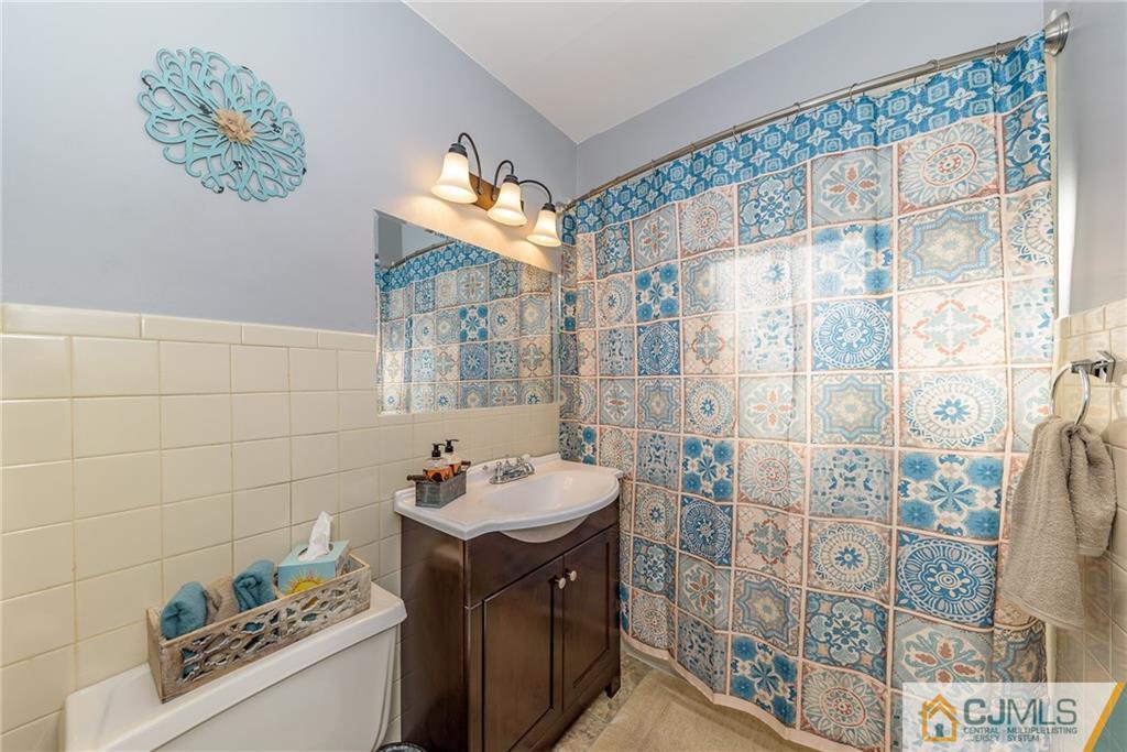 7 Exeter Road Fords, NJ 08863 - Photo 12 of 25 a bathroom with a sink a vanity and a shower