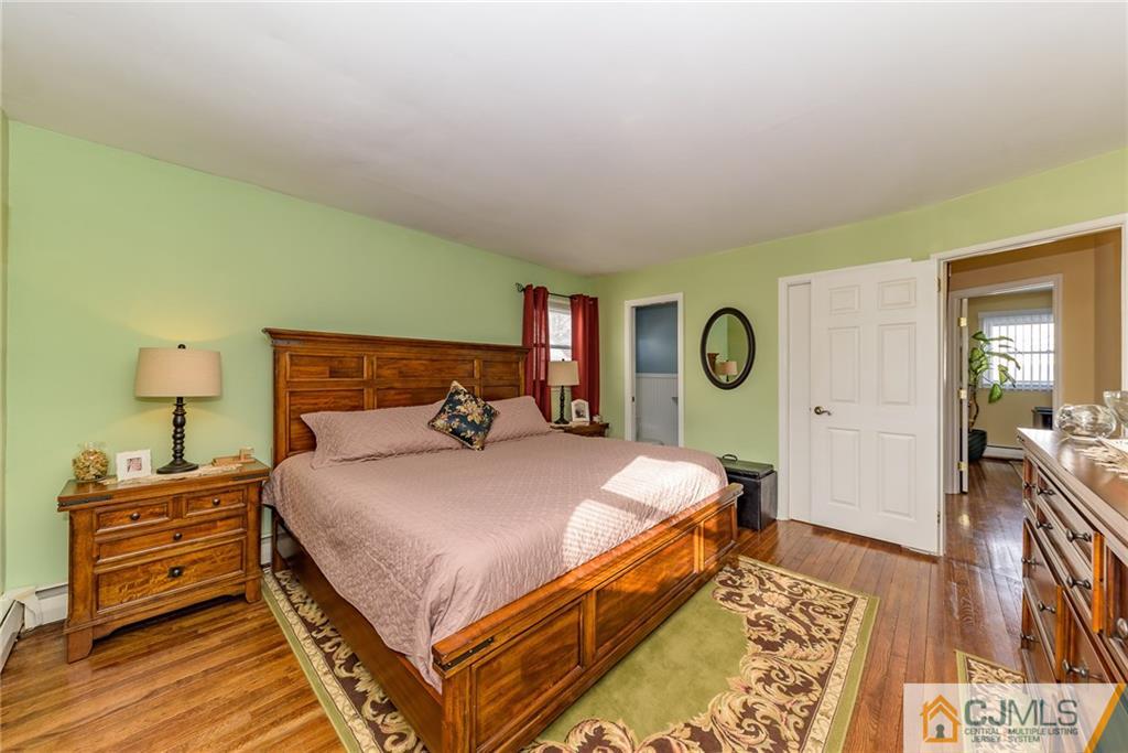7 Exeter Road Fords, NJ 08863 - Photo 14 of 25 a bedroom with a bed and dresser with mirror