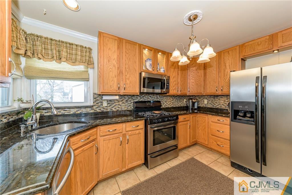 7 Exeter Road Fords, NJ 08863 - Photo 7 of 25 a kitchen with stainless steel appliances granite countertop a refrigerator a stove a sink and a microwave