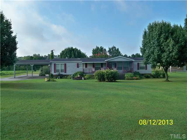 7300 Martin Road Zebulon, NC 27597 - Photo 1 of 9 a view of a house with a back yard