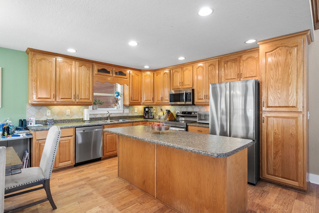 961 South Brooks Cove Road Hayesville, NC 28904 - Photo 11 of 55 a kitchen with stainless steel appliances granite countertop a refrigerator a sink dishwasher a stove and a refrigerator
