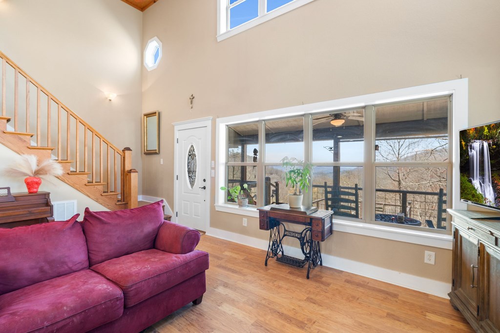 961 South Brooks Cove Road Hayesville, NC 28904 - Photo 14 of 55 a living room with furniture and a floor to ceiling window or hardwood