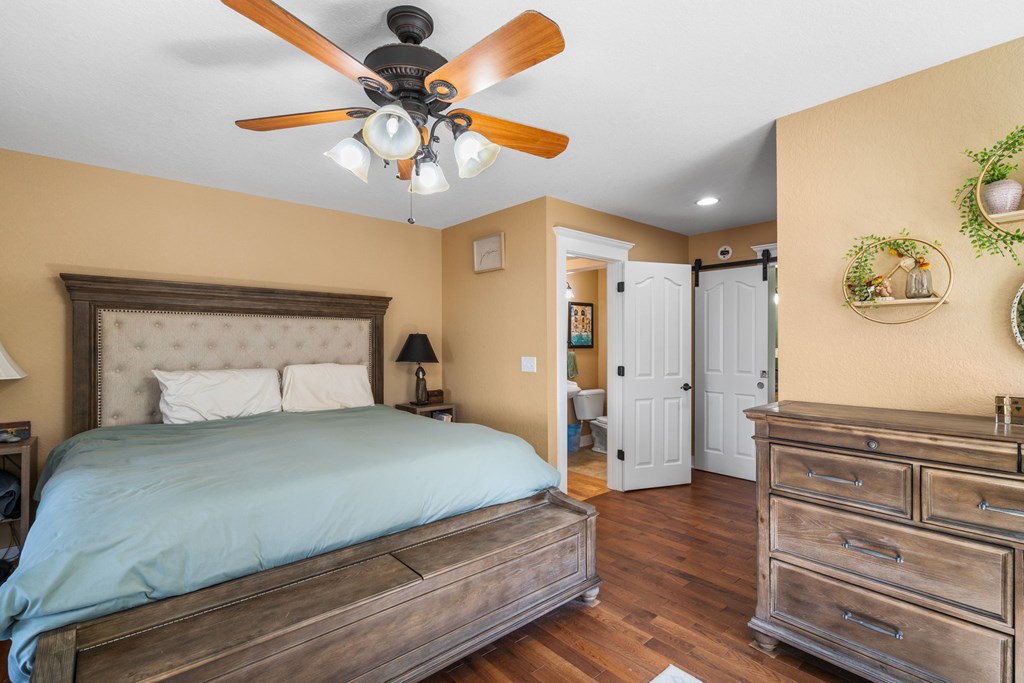 961 South Brooks Cove Road Hayesville, NC 28904 - Photo 18 of 55 a bedroom with a bed and a chandelier