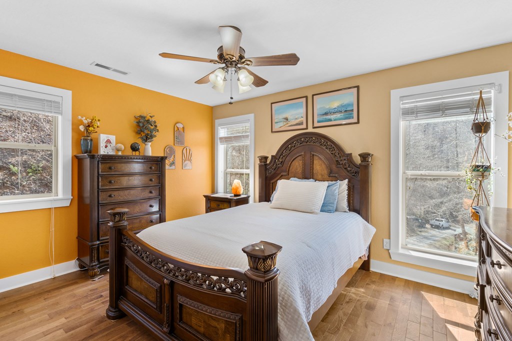 961 South Brooks Cove Road Hayesville, NC 28904 - Photo 19 of 55 a bedroom with a bed a chandelier and a window