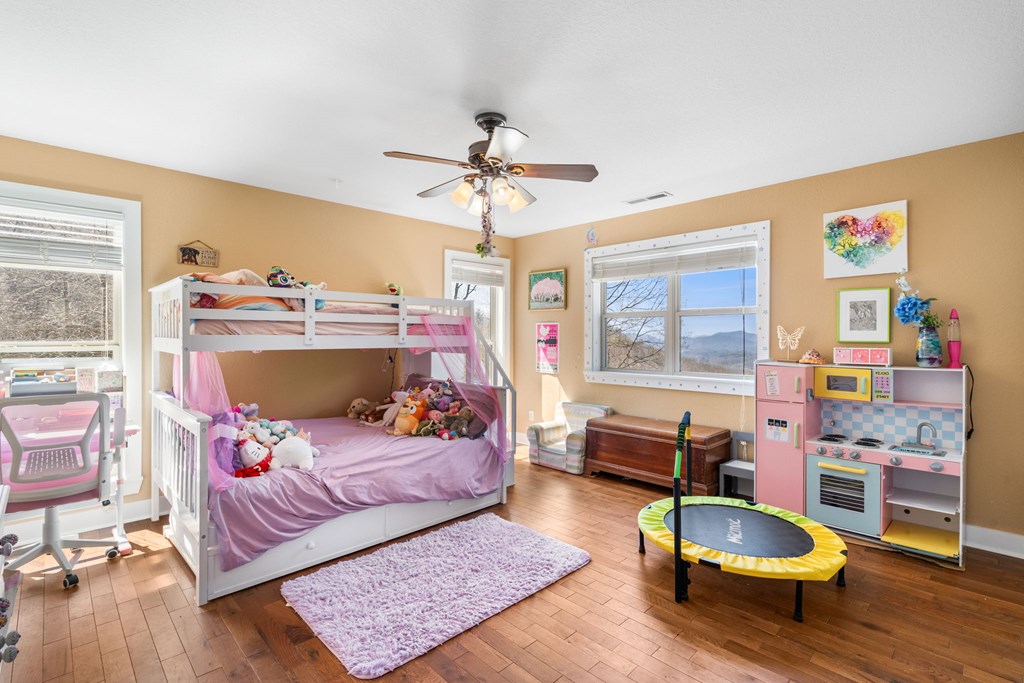 961 South Brooks Cove Road Hayesville, NC 28904 - Photo 21 of 55 a bed room with a bed and a chair