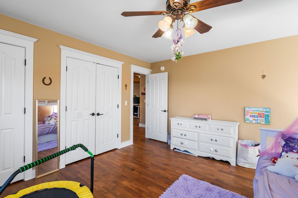 961 South Brooks Cove Road Hayesville, NC 28904 - Photo 22 of 55 a view of a bedroom with wooden floor and ceiling fan