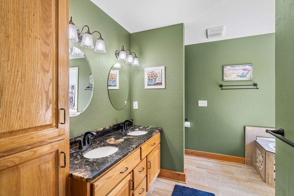 961 South Brooks Cove Road Hayesville, NC 28904 - Photo 26 of 55 a bathroom with a granite countertop sink a mirror and a