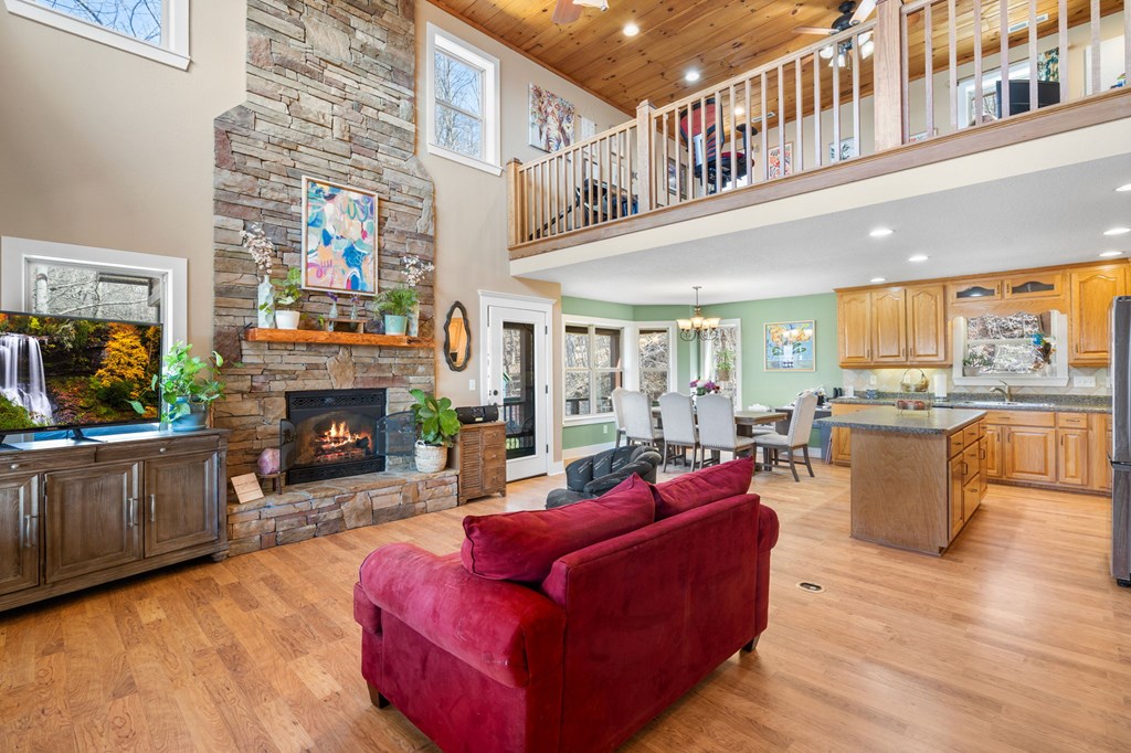 961 South Brooks Cove Road Hayesville, NC 28904 - Photo 6 of 55 a living room with furniture a fireplace and a floor to ceiling window