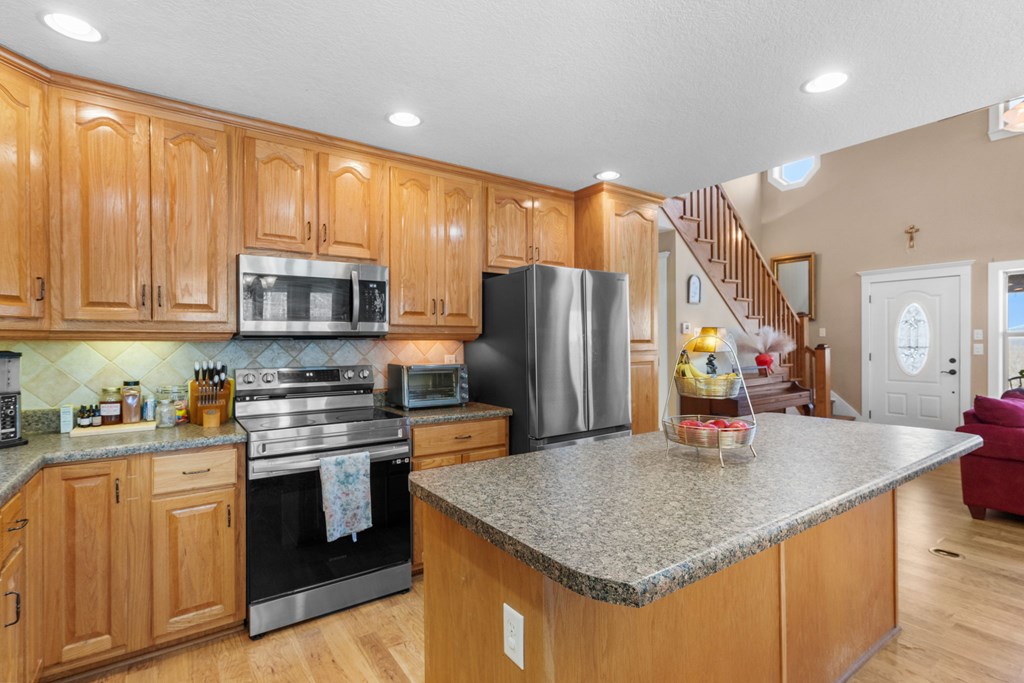 961 South Brooks Cove Road Hayesville, NC 28904 - Photo 9 of 55 a kitchen with stainless steel appliances granite countertop a sink a stove and refrigerator
