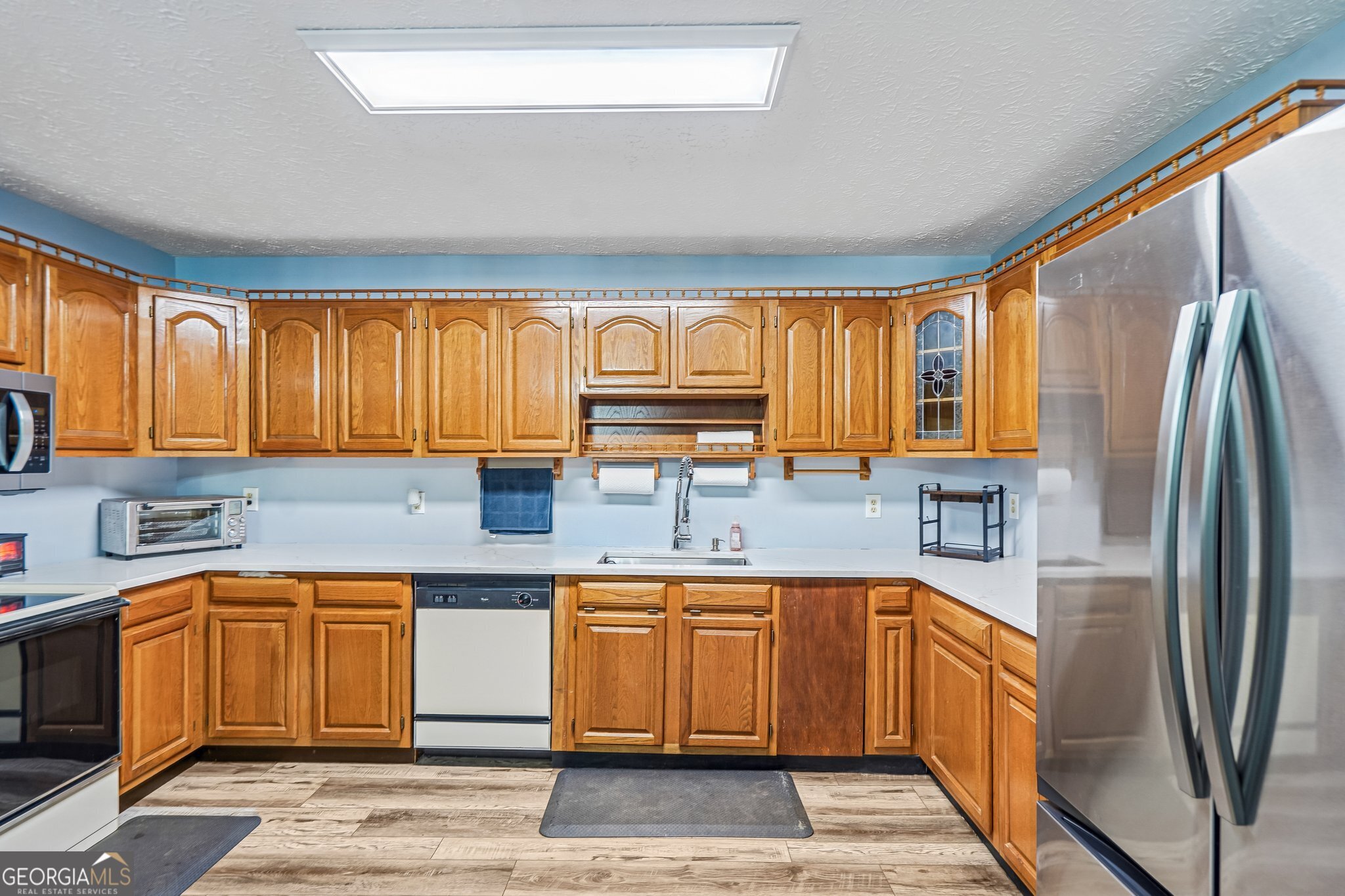 241 Busbin Road Fayetteville, GA 30215 - Photo 15 of 45 a kitchen with a sink refrigerator and cabinets