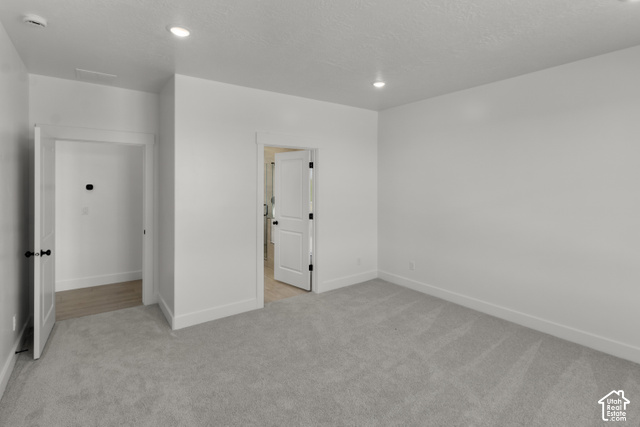 205 East 690th Street North Logan, UT 84321 - Photo 42 of 52 Neutral wall tones with recessed lighting, light-toned carpet, and solid core doors with black hardware