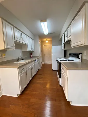 a kitchen with stainless steel appliances granite countertop a sink stove and cabinets