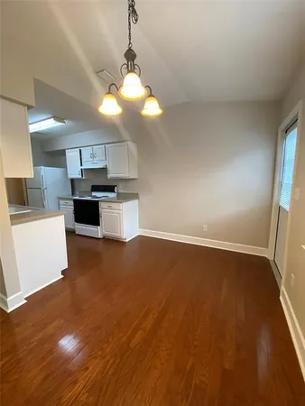 a view of a kitchen with a sink cabinets and wooden floor