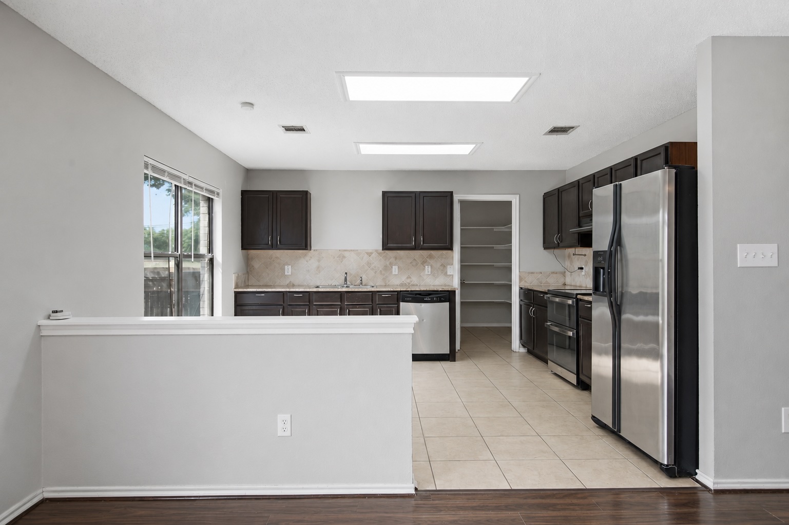 7900 Rosenberry Drive Austin, TX 78747 - Photo 10 of 27 A well-equipped kitchen features sleek stainless steel appliances and ample cabinetry.