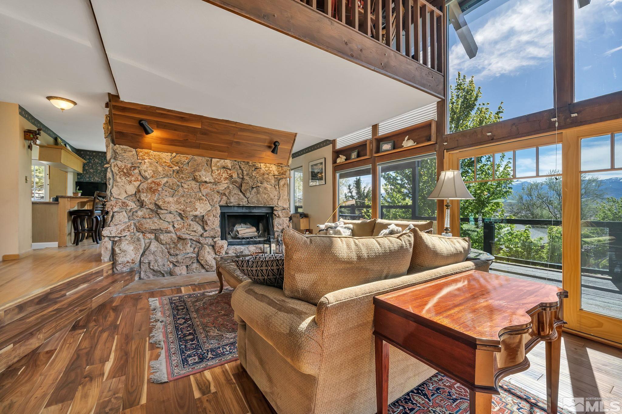 14615 Virginia Foothills Drive Reno, NV 89521 - Photo 12 of 27 a living room with fireplace furniture and a floor to ceiling window
