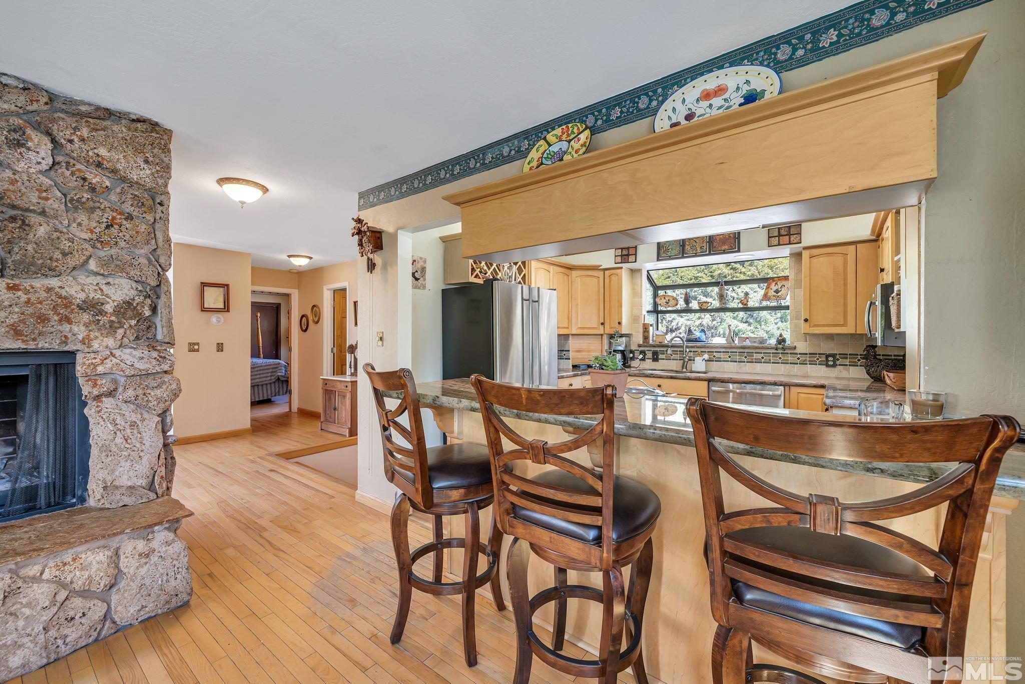14615 Virginia Foothills Drive Reno, NV 89521 - Photo 15 of 27 a dining room with furniture and wooden floor