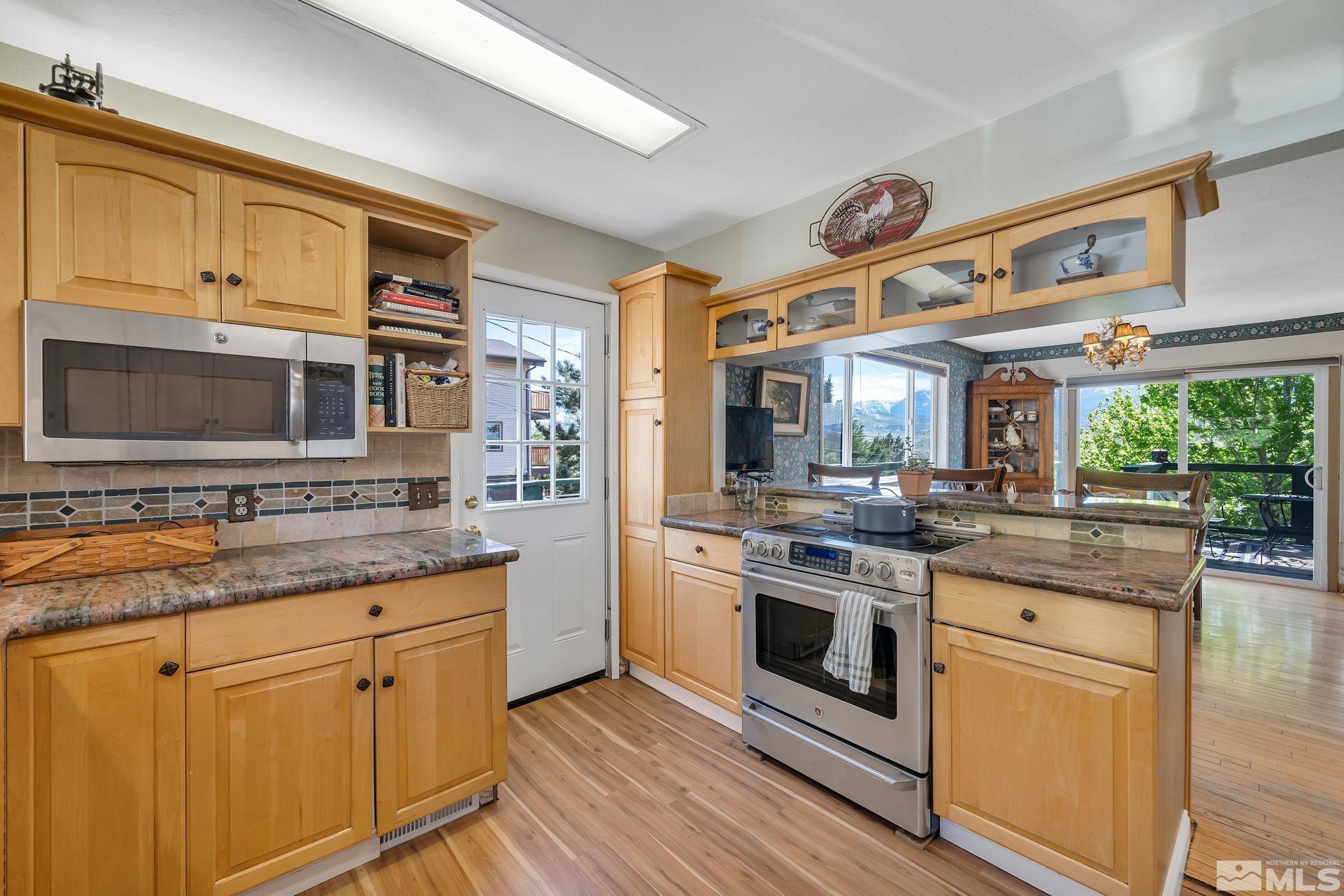 14615 Virginia Foothills Drive Reno, NV 89521 - Photo 18 of 27 a kitchen with stainless steel appliances granite countertop a stove and a sink